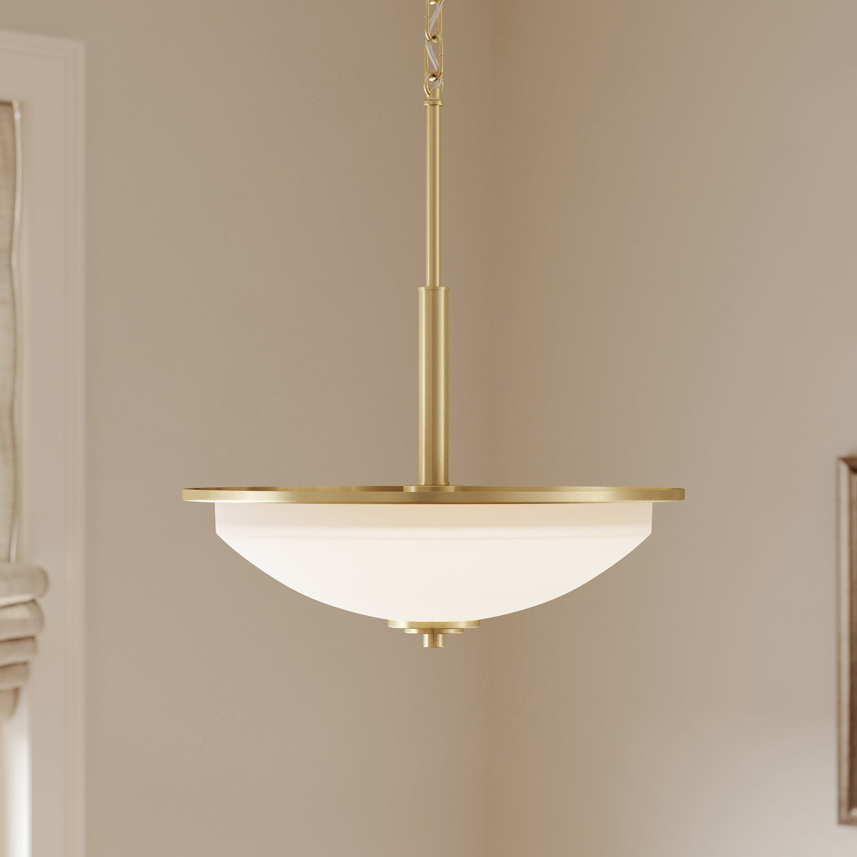 Pendant light fixture with white glass shade on a beige wall. 