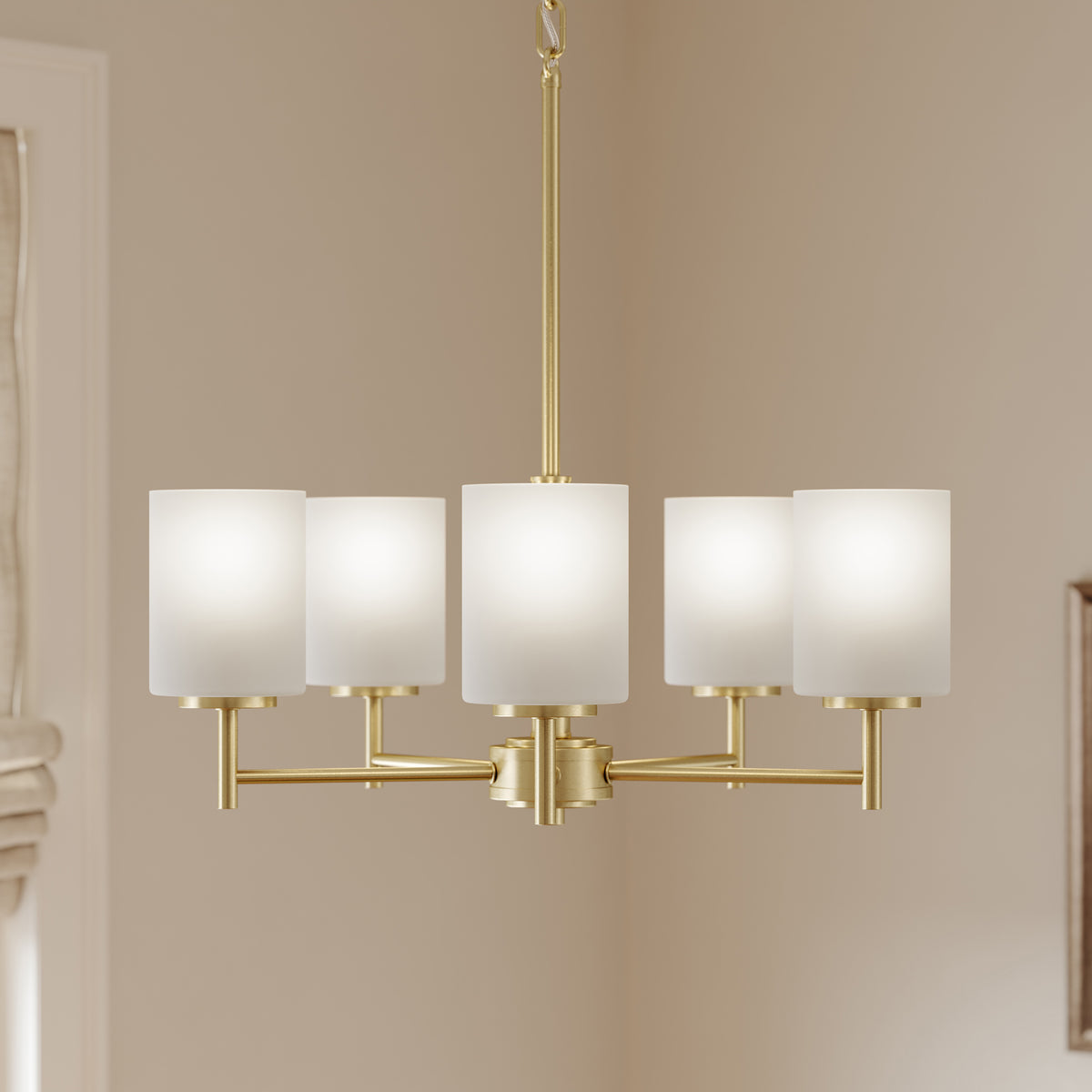 Modern chandelier with gold frame and white lampshades on a neutral wall. 