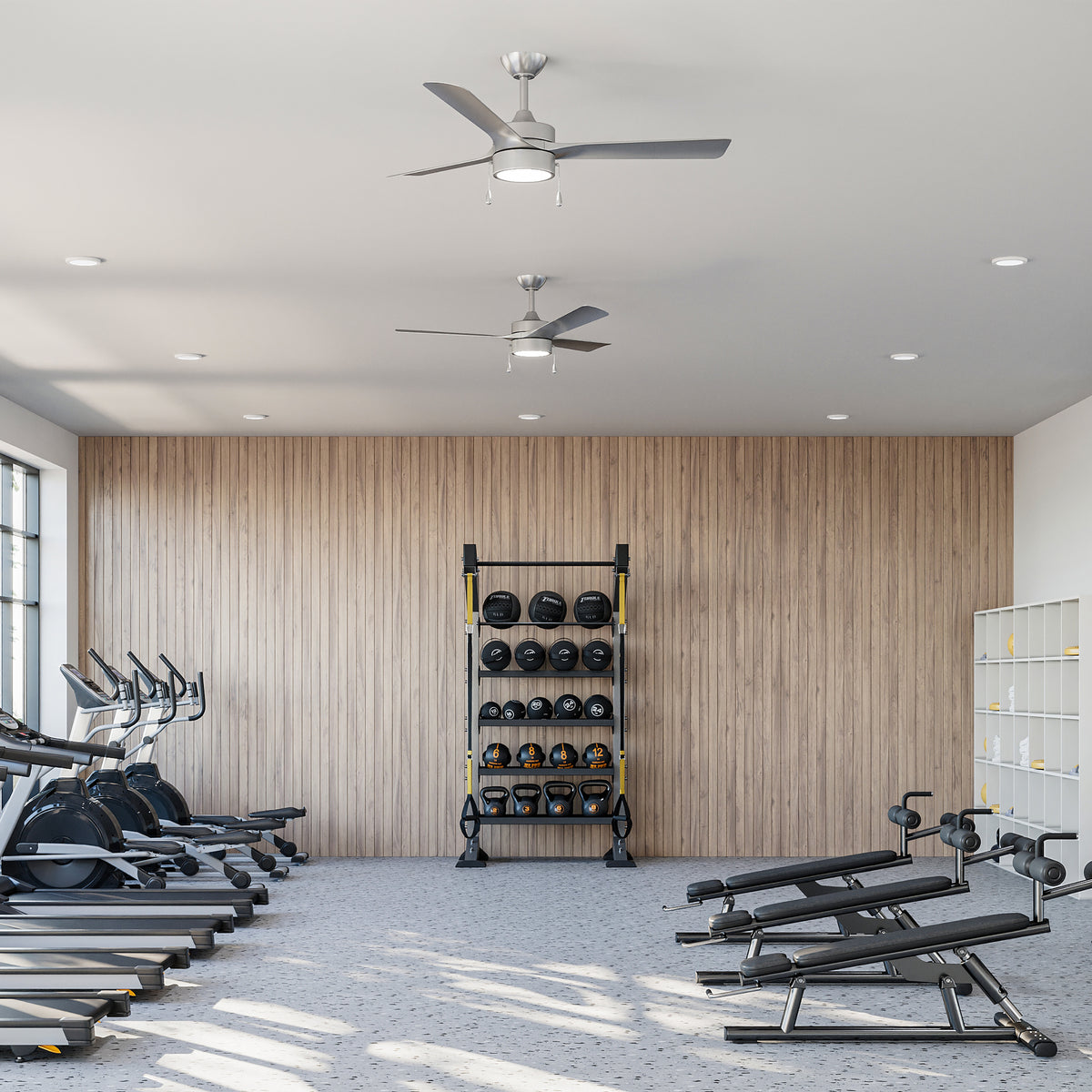 Gym interior with P250122-009-30 ceiling fans with exercise equipment against a wooden wall. 