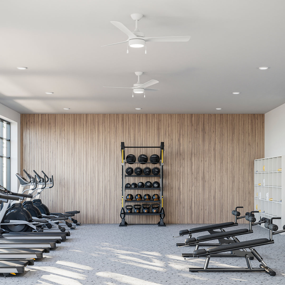 Gym interior with P250122-28M-30 ceiling fans with cardio machines, weight rack, and free weights against a wooden wall. 