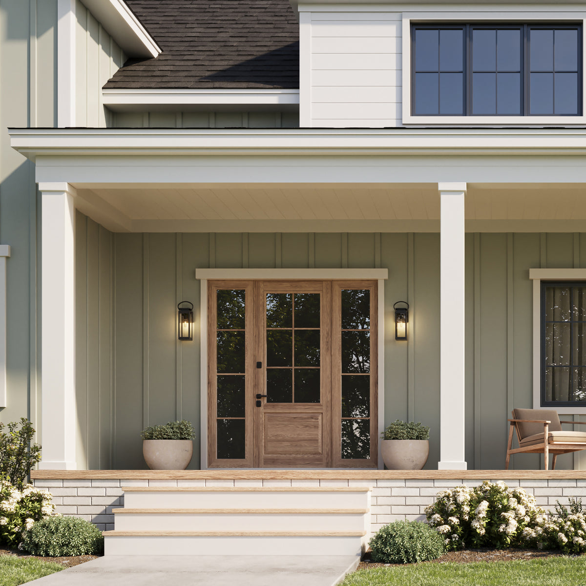 Front view of a house with a wooden door and porch lights. 